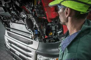 Auto Mechanic Looking Under Hood Of Car. photo