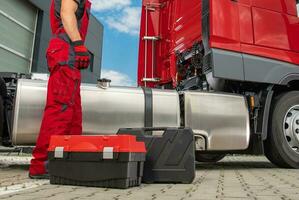 Semi Truck Mechanic in Front of Broken Vehicle photo