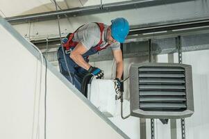 HVAC Technician Installing New Warehouse Air and Water Heaters photo