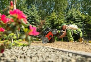 Landscaping Worker Checking His Gasoline Aerator photo