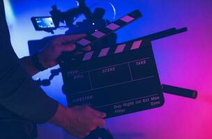 Film Making Professional with Clapperboard in His Hands photo