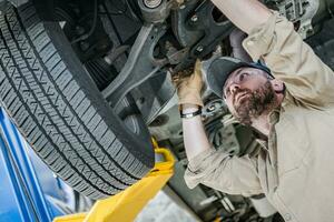 Vehicle Suspension Problem Solving by Car Mechanic photo