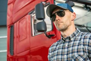 Portrait of Caucasian Truck Driver in Front of His Vehicle photo