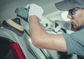 Collision Center Worker Polishing Car Body photo