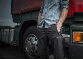 Caucasian Trucker Next To His Semi Truck photo