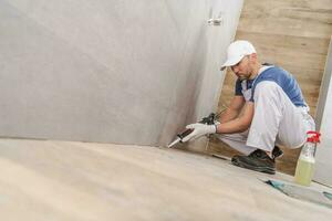 Worker Sealing Ceramic Tiles photo