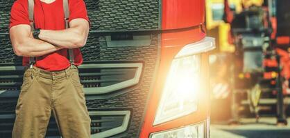 European Semi Truck Driver in Front of His Modern Semi Tractor photo