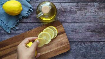 Lemon essential oil on a chopping board on table video