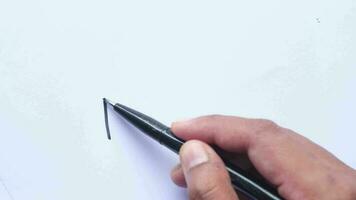 Man's hand writing with pen on paper. video
