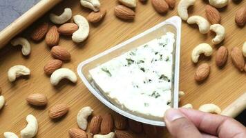 close up of fresh cheese, cashed and almond nut on table video