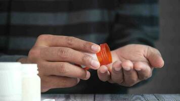 Man's hand with medicine spilled out of the pill container video