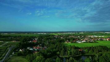 Aerial descending view of a village and lake video