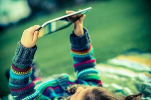 Girl in Park with Tablet photo