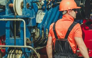 Heavy Machines Operator Worker in Front of Large Crane photo