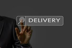 E-commerce concept with a person touching a button on a digital interface with icons of delivery, delivery truck. symbol of online purchase on internet photo