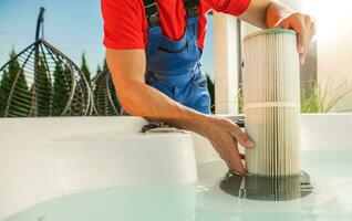 Hot Tubs Technician Replacing Water Filter photo