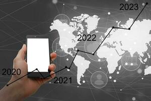 Man's hand pointing graph of success in 2022 year. Growing business concept photo