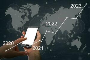 Man's hand pointing graph of success in 2022 year. Growing business concept photo