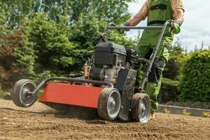 Gardener Pushing Gasoline Lawn Aerator photo