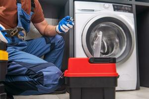 Professional Worker Installing Washing Machine photo