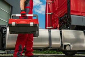 Semi Trucks Professional Mechanic with His Tools Box in Hand photo