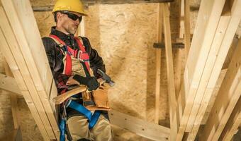 Contractor with Hammer on Construction Site photo