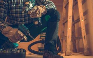 General Woodwork Contractor with Drill Drivers in Both Hands photo