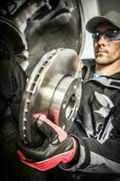 Car Mechanic Replacing Car Disc Brakes. photo