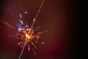 A lit sparkler showing bright sparks photo