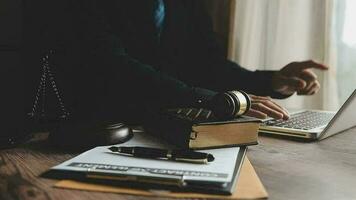 Business and lawyers discussing contract papers with brass scale on desk in office. Law, legal services, advice, justice and law concept picture with film grain effect video