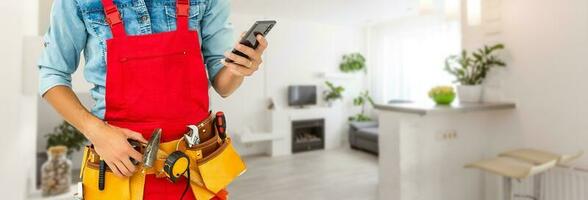 Builder handyman with construction tools. House renovation background. photo