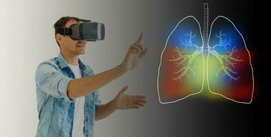 a man in virtual 3 d glasses looks at the lungs, coronavirus, pneumonia photo