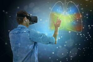 a man in virtual 3 d glasses looks at the lungs, coronavirus, pneumonia photo