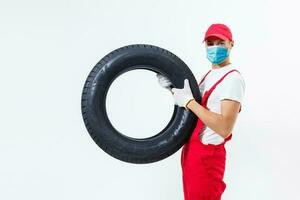 tireman in protective mask, wearing face protection in prevention for coronavirus. COVID-19 Pandemic Coronavirus photo