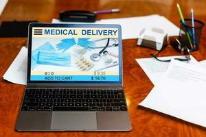 Online pharmacy. Application in your laptop for online ordering of medicines. laptop close-up. Lots of pills. photo