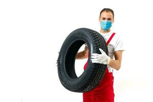 tireman in protective mask, wearing face protection in prevention for coronavirus. COVID-19 Pandemic Coronavirus photo