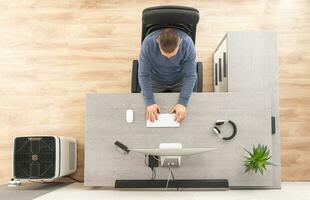 Home Office Worker in Front of Computer Top View photo