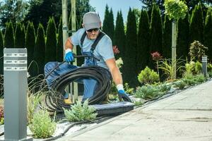 Landscaping Worker Preparing Trickle Irrigation Plastic Pipe photo