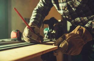 Construction Worker Working on His Woodwork Project photo