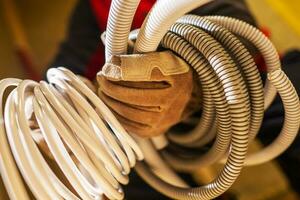 Electrician with Plastic Electric System Conduits in His Hands photo