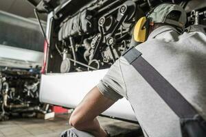 Car Service Worker Checking the Engine photo