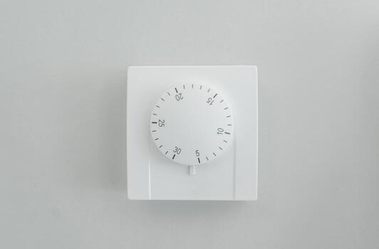 Modern Wall Heating and Cooling Thermostat with Manual Celsius Dial. photo