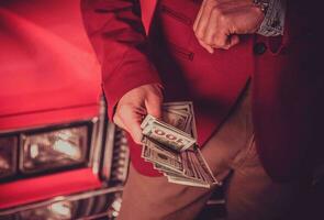 Car Salesman with Cash Dollars in His Hands photo