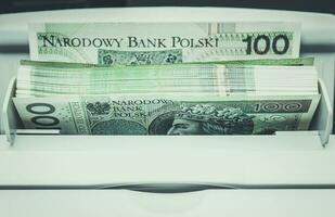 Polish Zloty Banknotes Inside Bills Counting Machine photo