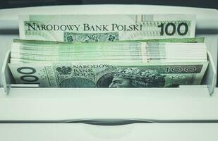 Polish Zloty Banknotes Inside Bills Counting Machine photo