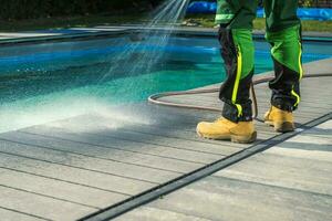 Outdoor Poolside Cleaning Using Garden Hose photo