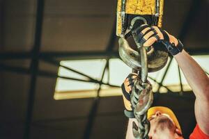 Construction Worker Hanging the Load on the Hook photo