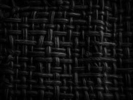 Dark black Abstract woven mat texture. Wickerwork background created with technology photo