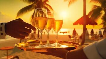 Waiter serving champagne on a tray. Summer beach sunset holiday vacation at beach with palm trees, photo