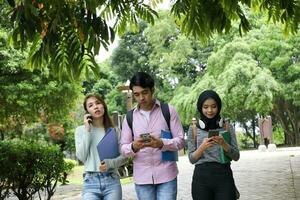 Young asian malay chinese man woman indoor stair corridor campus book file folder laptop computer phone sit stand study mingle photo